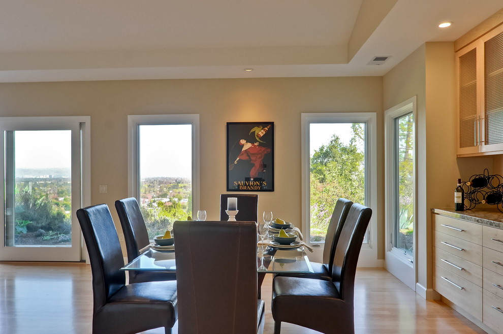 This is an example of a large retro open plan dining room in San Francisco with beige walls, light hardwood flooring, no fireplace and beige floors.