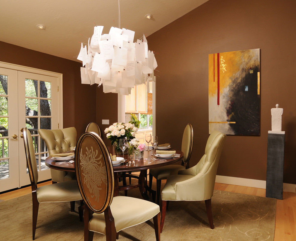 Design ideas for an eclectic dining room in San Francisco with brown walls and medium hardwood flooring.