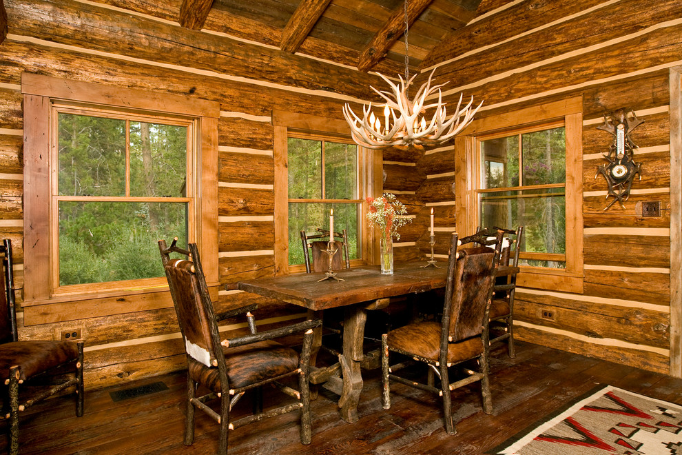 This is an example of a rustic dining room in Other with dark hardwood flooring.