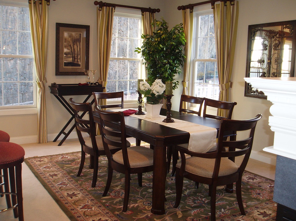 Enclosed dining room - mid-sized traditional carpeted and beige floor enclosed dining room idea in New York with a two-sided fireplace and beige walls