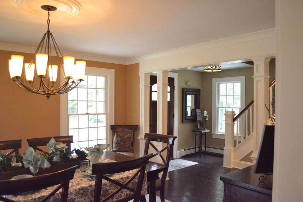 Medium sized classic kitchen/dining room in New York with light hardwood flooring and orange walls.