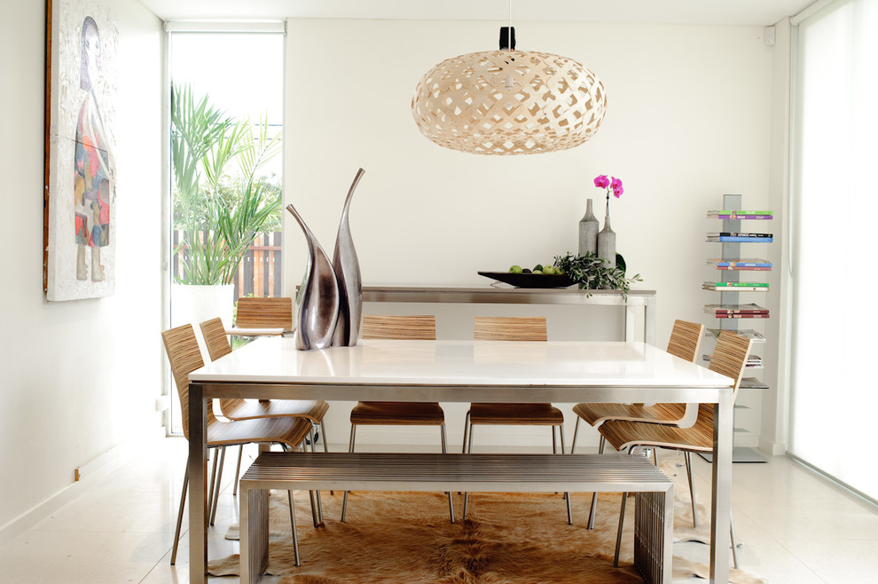 This is an example of a medium sized contemporary kitchen/dining room in Sydney with white walls and no fireplace.