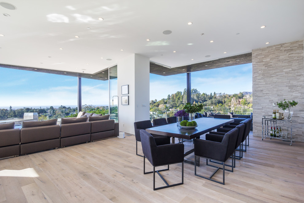 Contemporary open plan dining room in Los Angeles with white walls and light hardwood flooring.