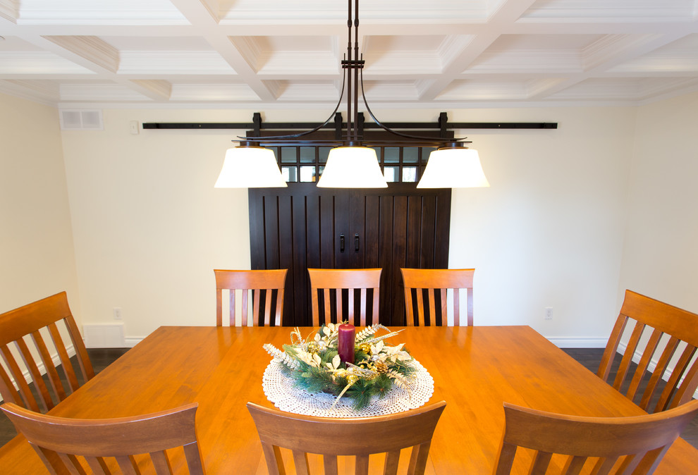 This is an example of a medium sized traditional enclosed dining room in Toronto with yellow walls, dark hardwood flooring and no fireplace.
