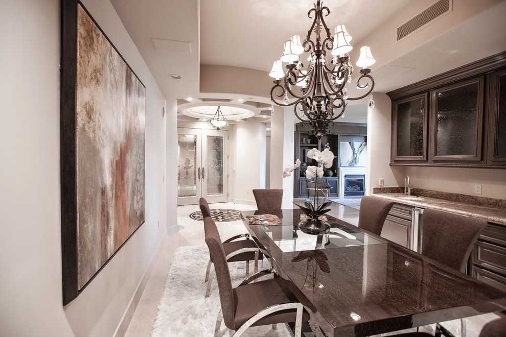 Medium sized modern enclosed dining room in Las Vegas with beige walls and marble flooring.
