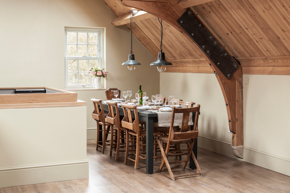 Farmhouse dining room in Hertfordshire with beige walls, light hardwood flooring and no fireplace.