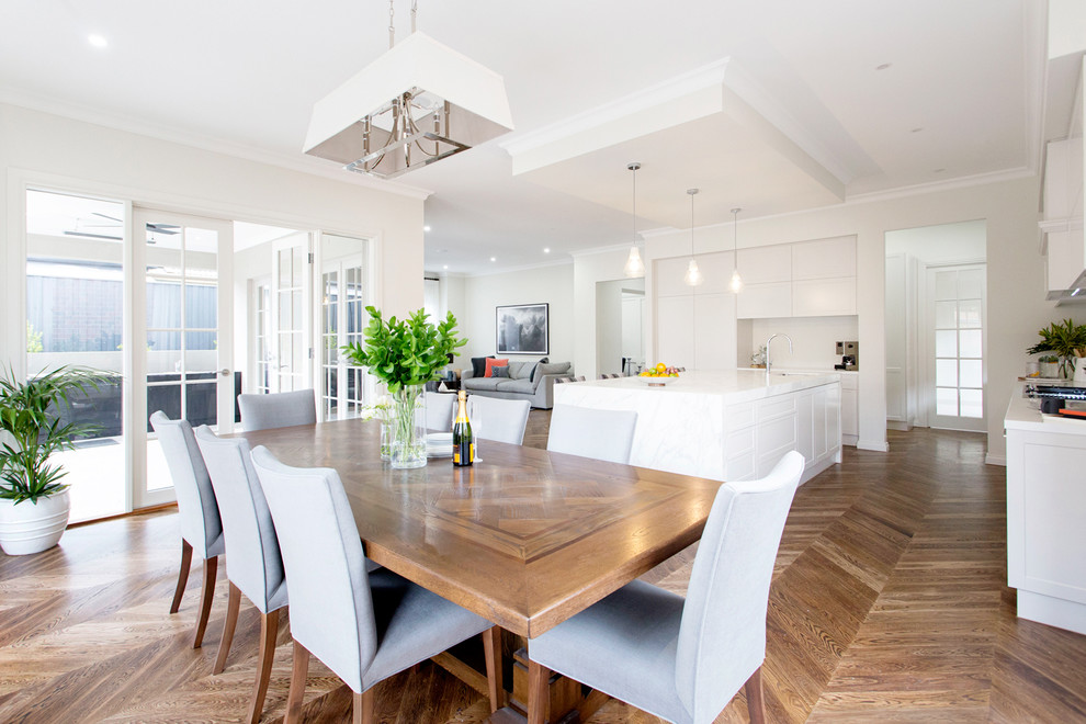 Photo of a large open plan dining room in Melbourne with white walls, dark hardwood flooring and brown floors.
