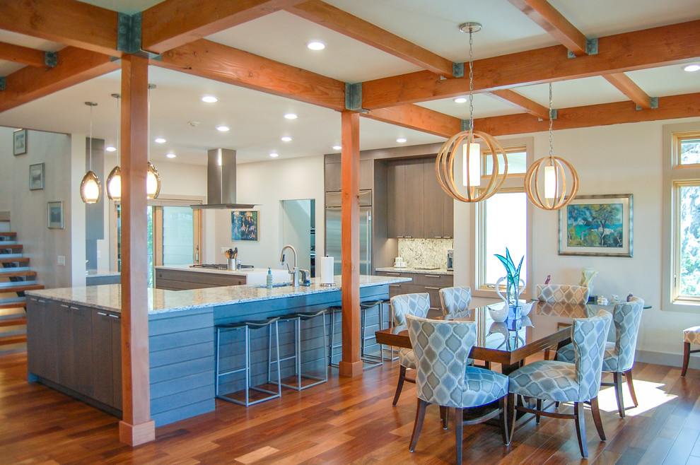 This is an example of a contemporary open plan dining room in Atlanta with white walls and medium hardwood flooring.