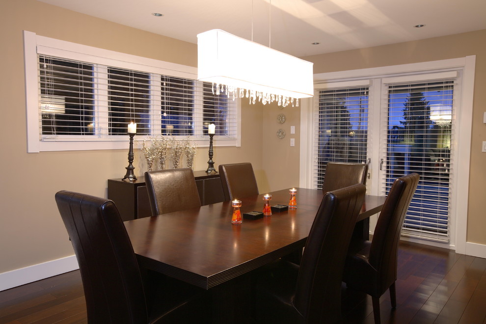 Example of a mid-sized transitional dark wood floor and brown floor enclosed dining room design in Vancouver with beige walls and no fireplace