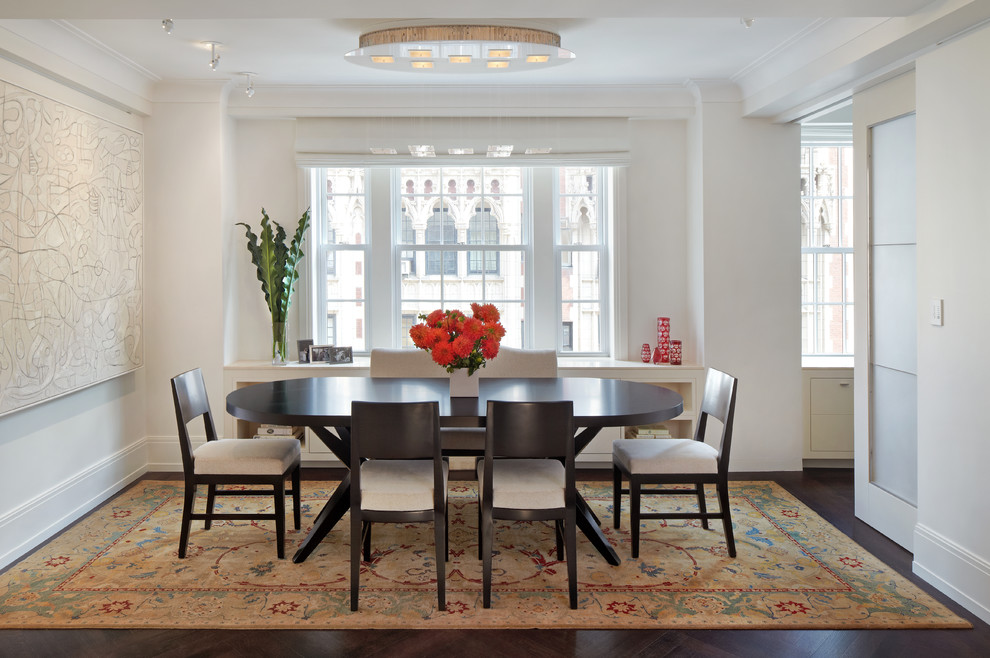 Enclosed dining room - mid-sized transitional dark wood floor enclosed dining room idea in New York with white walls and no fireplace