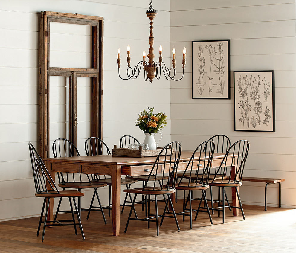 Country dining room in Houston with white walls and medium hardwood flooring.