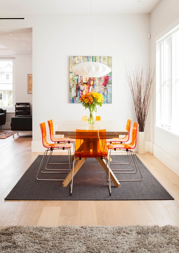 Example of a minimalist dining room design in Vancouver with white walls