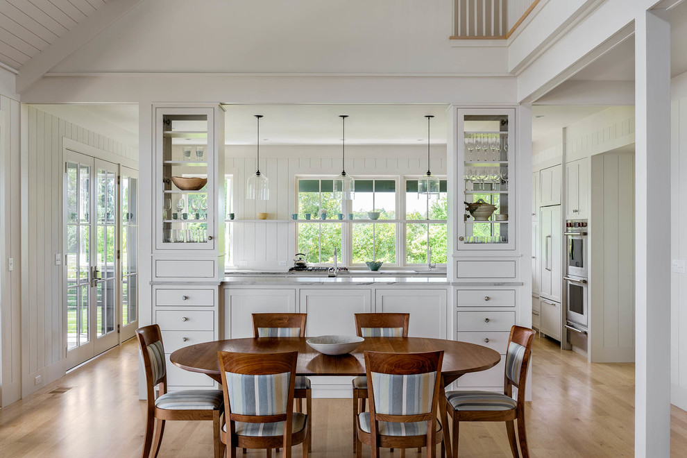 Kitchen/dining room combo - mid-sized coastal light wood floor kitchen/dining room combo idea in Portland Maine with white walls