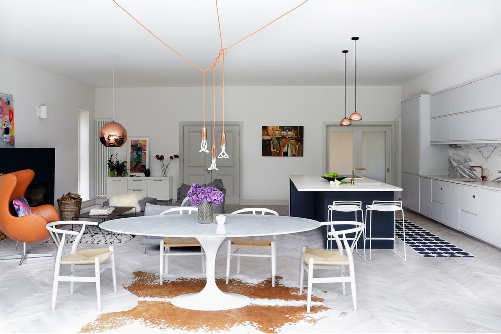 Example of a large trendy light wood floor dining room design in Dublin with white walls