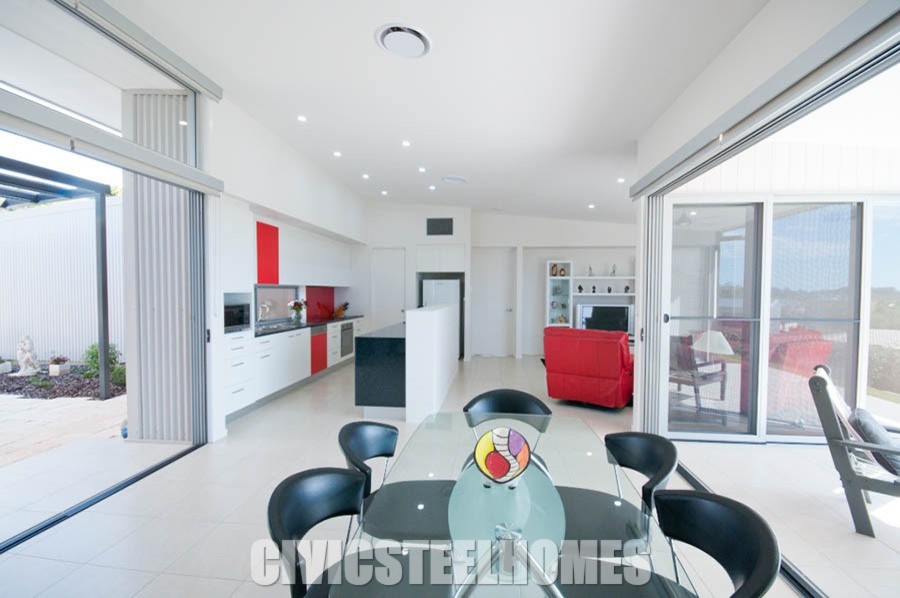 Inspiration for an expansive contemporary kitchen/dining room in Sunshine Coast with white walls and porcelain flooring.