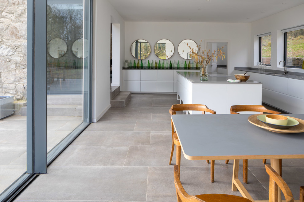 Inspiration for a large contemporary kitchen/dining room in Devon with grey floors and white walls.