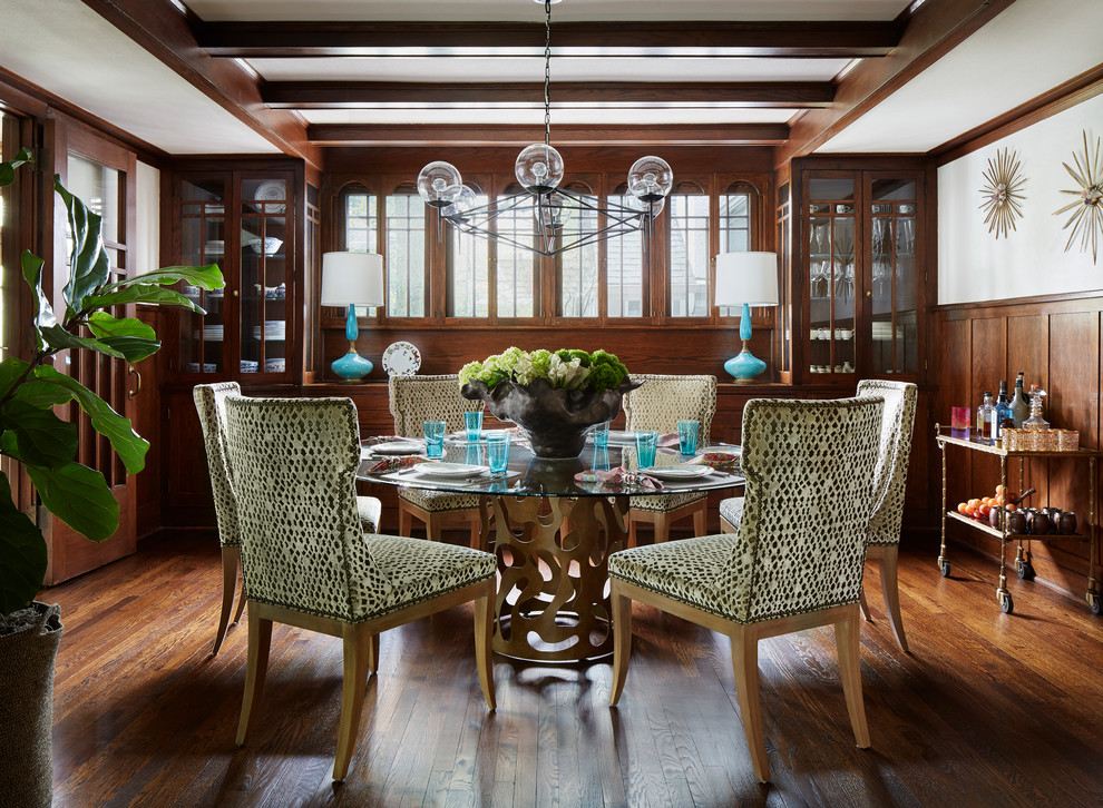 This is an example of a classic dining room in Chicago with white walls, dark hardwood flooring, brown floors and feature lighting.
