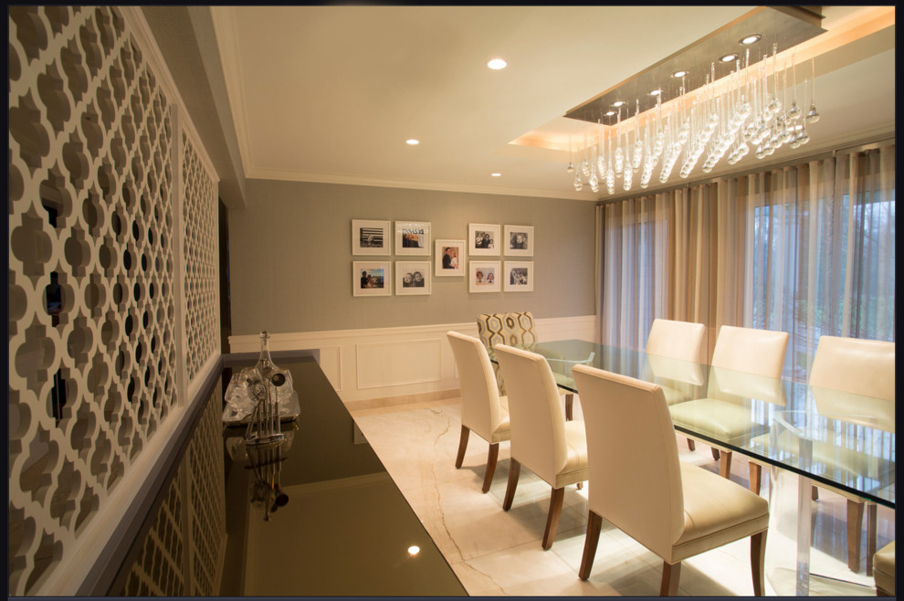 This is an example of a large contemporary dining room in New York with grey walls, marble flooring and no fireplace.