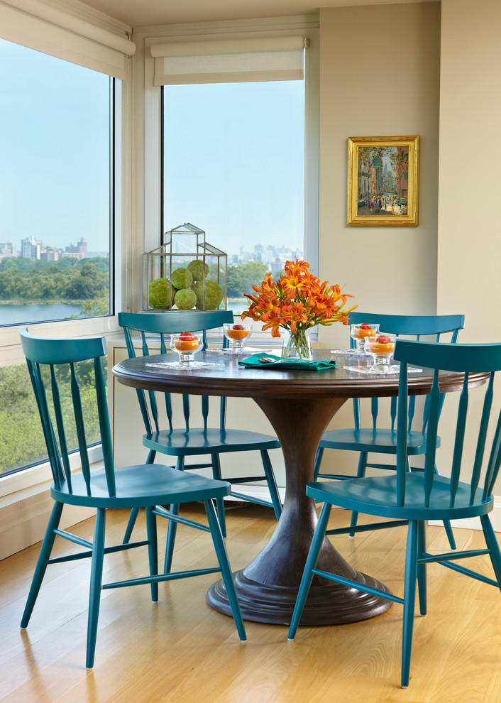 Example of a mid-sized transitional light wood floor kitchen/dining room combo design in New York with beige walls and no fireplace