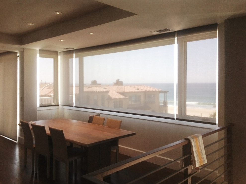 This is an example of a medium sized beach style open plan dining room in Los Angeles with white walls, dark hardwood flooring, no fireplace and brown floors.