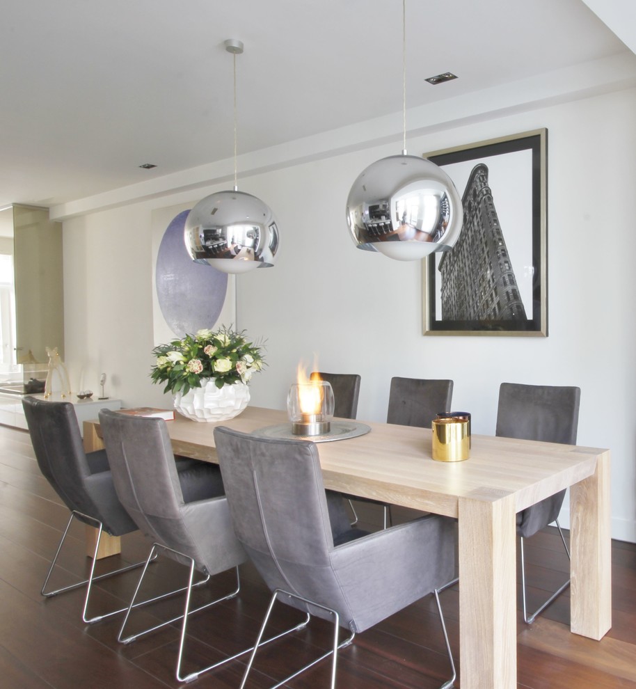 Inspiration for a medium sized contemporary dining room in Amsterdam with white walls and no fireplace.