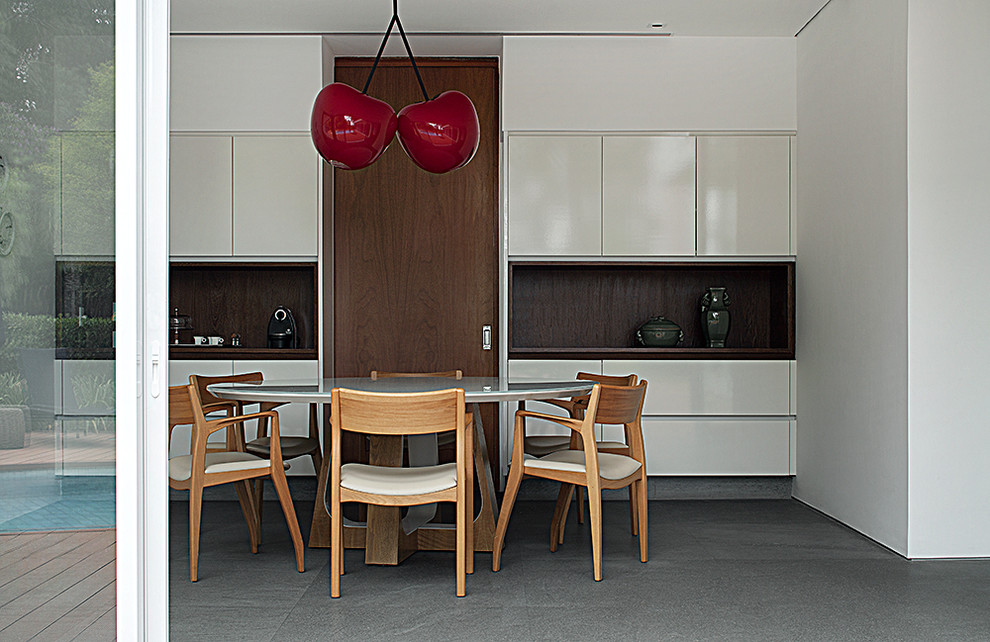 Idee per una sala da pranzo aperta verso la cucina contemporanea di medie dimensioni con pareti bianche e pavimento in cemento