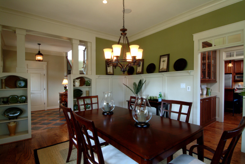 Example of a mid-sized classic light wood floor and brown floor kitchen/dining room combo design in Atlanta with green walls and no fireplace