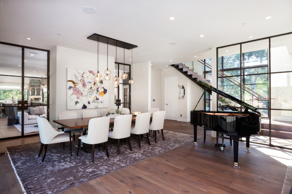 Contemporary dining room in San Francisco with white walls and dark hardwood flooring.