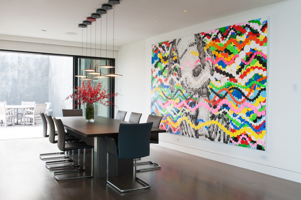 This is an example of an expansive contemporary open plan dining room in San Francisco with white walls and dark hardwood flooring.