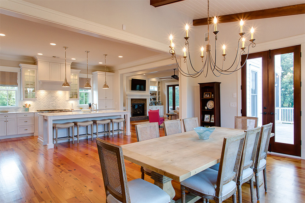 Large elegant medium tone wood floor kitchen/dining room combo photo in Charleston