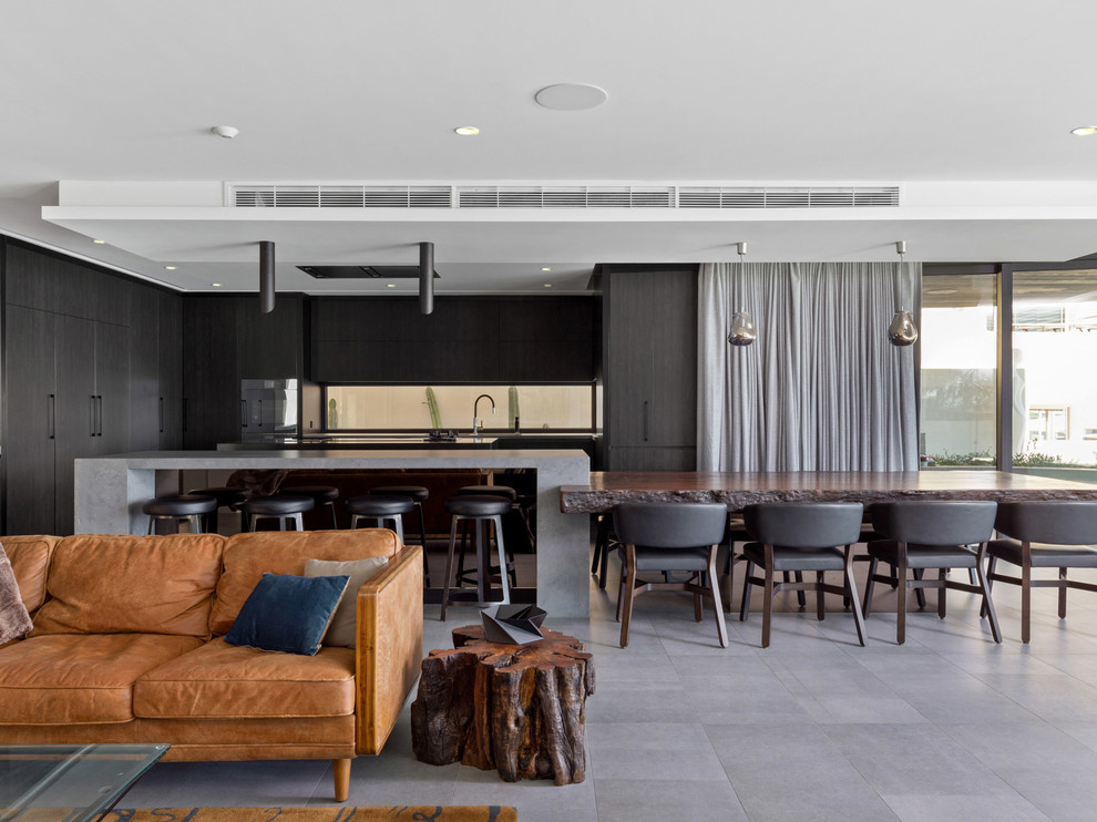 Inspiration pour une salle à manger ouverte sur le salon design avec un sol gris.