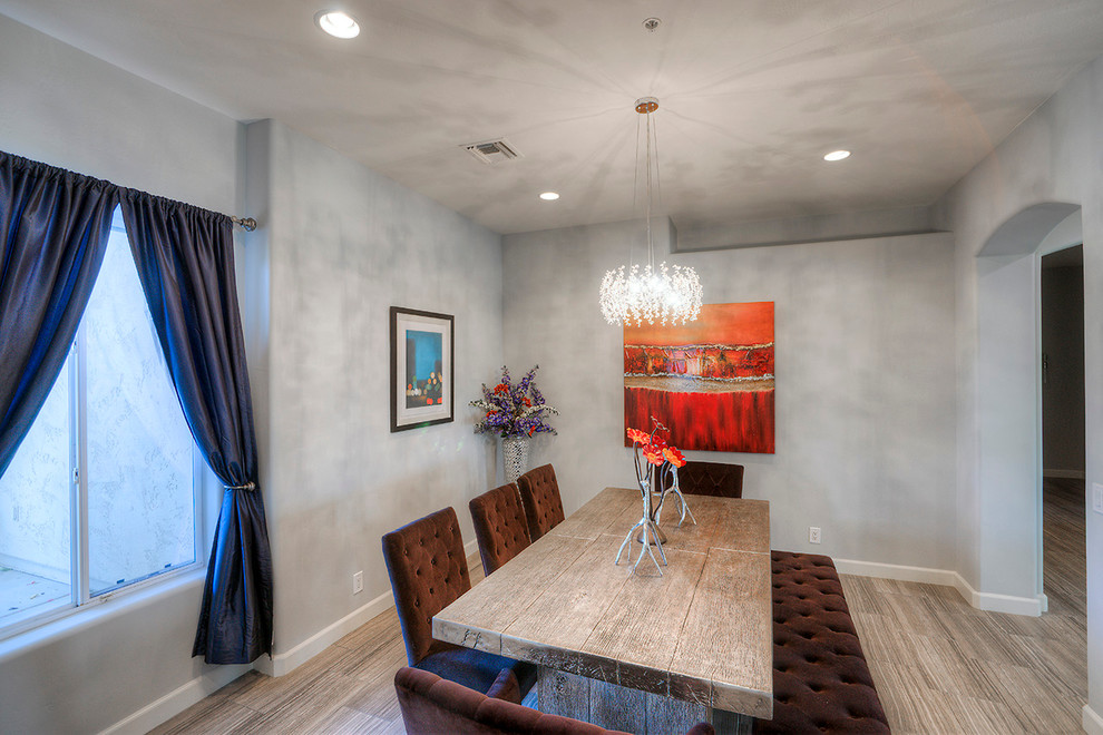 Example of a mid-sized minimalist enclosed dining room design in Phoenix with gray walls