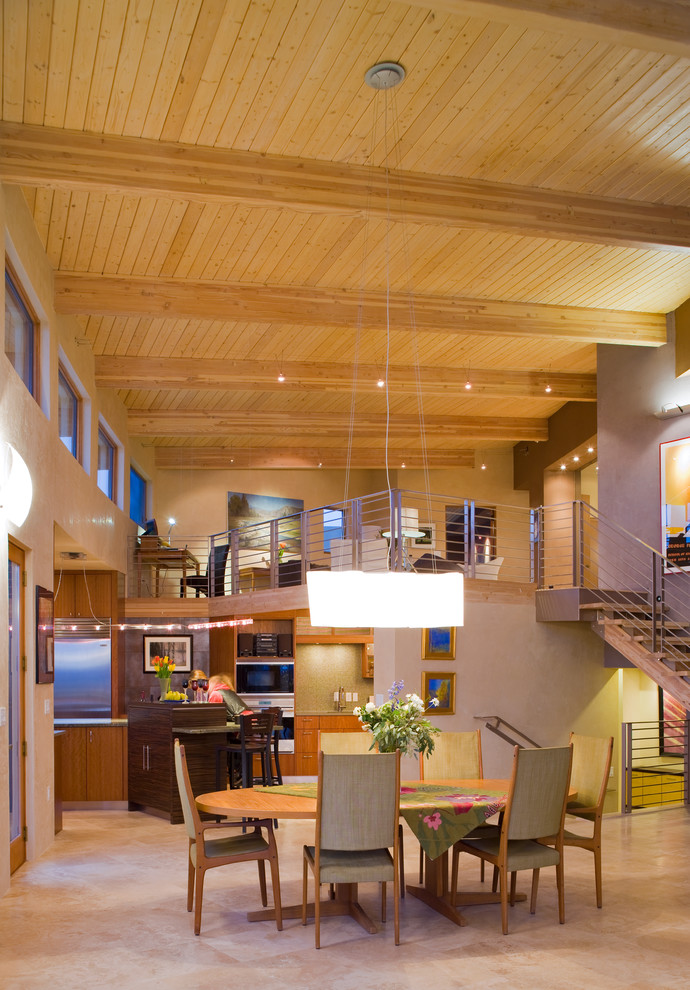 Immagine di un'ampia sala da pranzo aperta verso il soggiorno moderna con pareti beige e pavimento in travertino