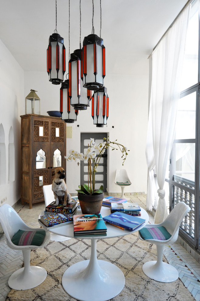 Inspiration for an eclectic dining room remodel in New York with white walls