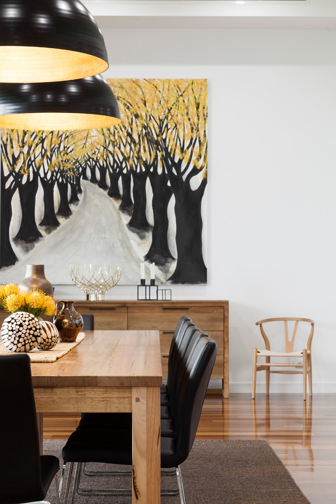 Contemporary dining room in Melbourne with white walls and medium hardwood flooring.