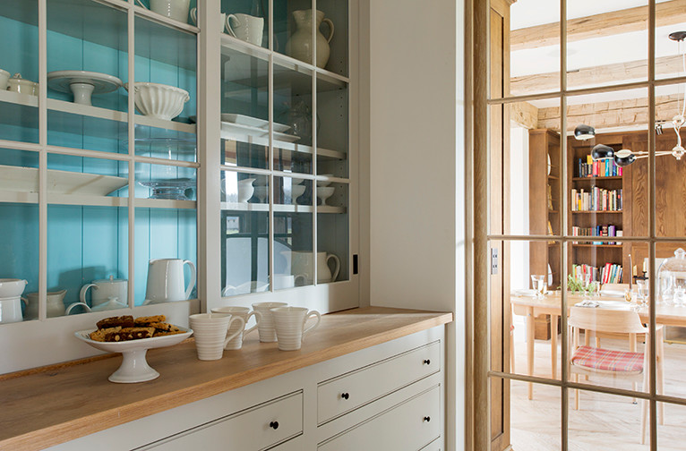 Foto de comedor de cocina campestre pequeño con paredes blancas, suelo de madera clara y suelo beige