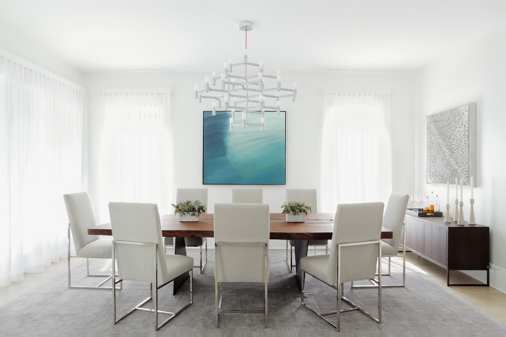 This is an example of a large contemporary dining room in Atlanta with white walls and light hardwood flooring.