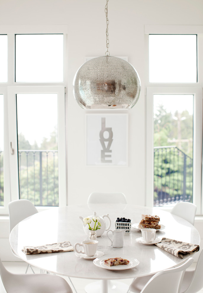 Example of a trendy dining room design in Vancouver with white walls