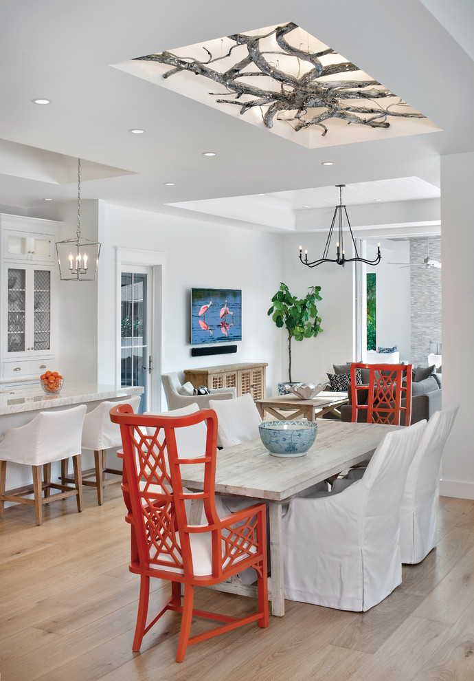 Great room - coastal light wood floor great room idea in Miami with white walls