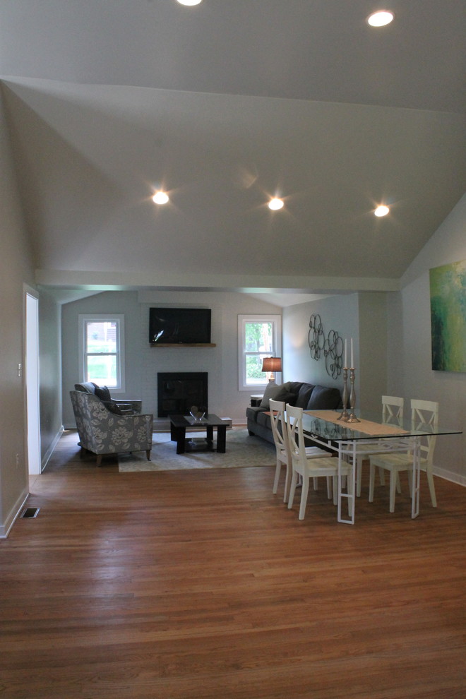 Inspiration for a small cottage medium tone wood floor great room remodel in Raleigh with gray walls