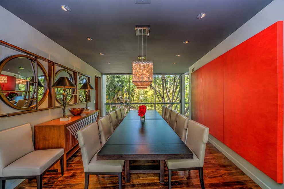 Expansive contemporary dining room in Los Angeles with grey walls, medium hardwood flooring, no fireplace and brown floors.