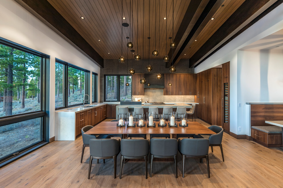 Photo of a contemporary kitchen/dining room in Sacramento with white walls, medium hardwood flooring and brown floors.