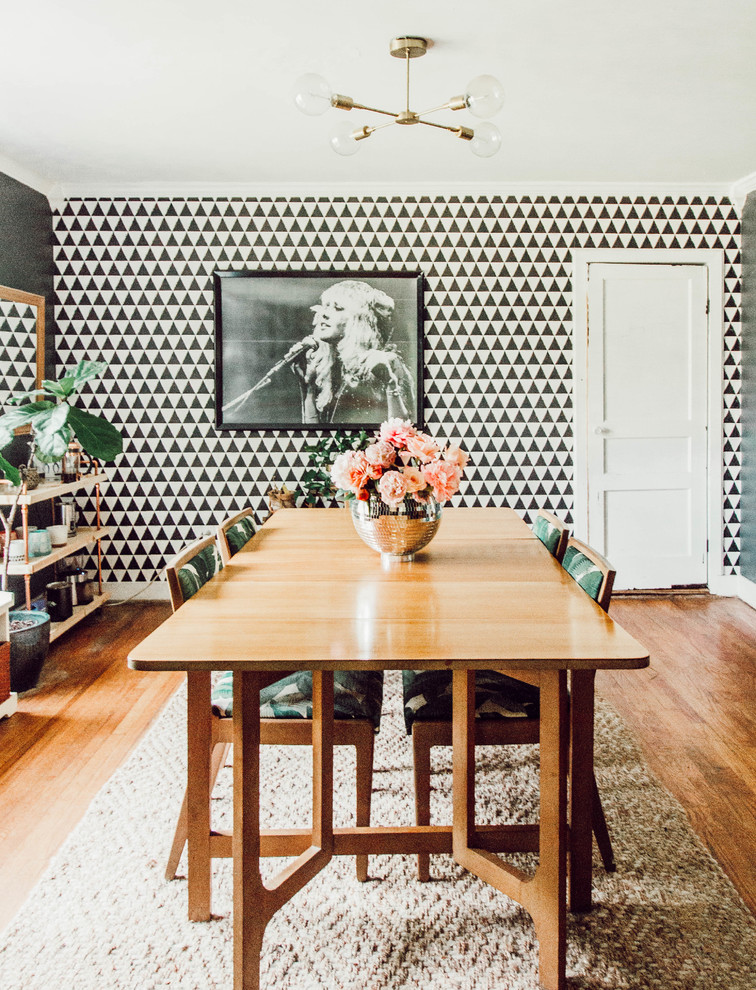 Design ideas for an eclectic enclosed dining room in Nashville with grey walls, medium hardwood flooring and brown floors.