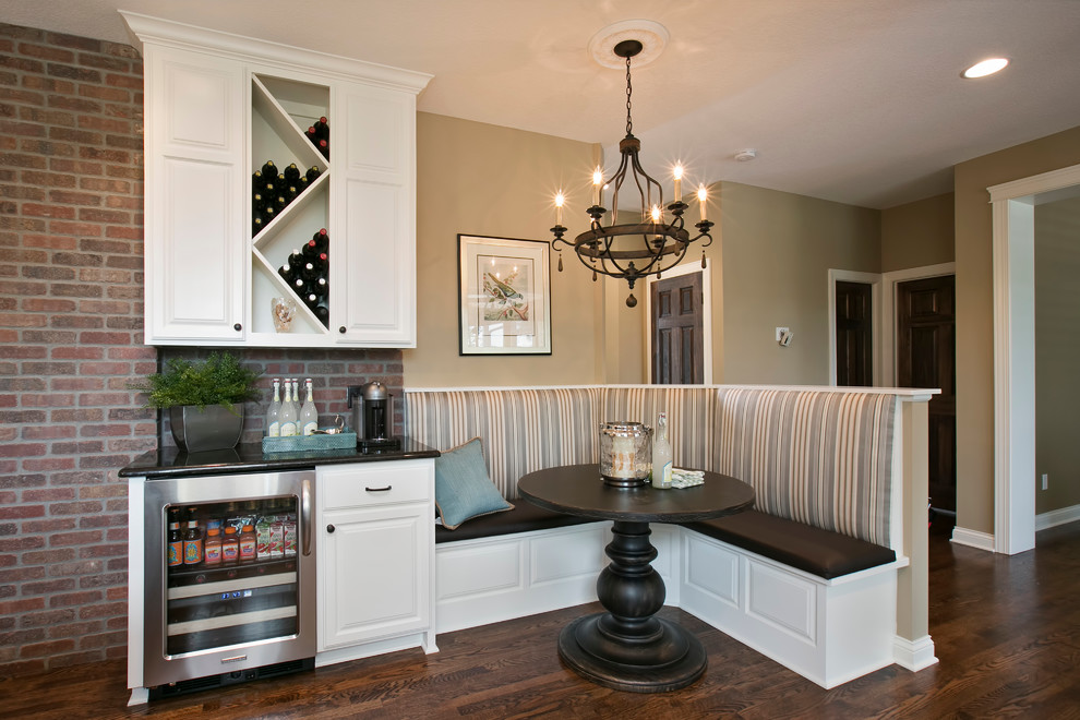 Example of a mid-sized classic dark wood floor and brown floor kitchen/dining room combo design in Minneapolis with beige walls and no fireplace