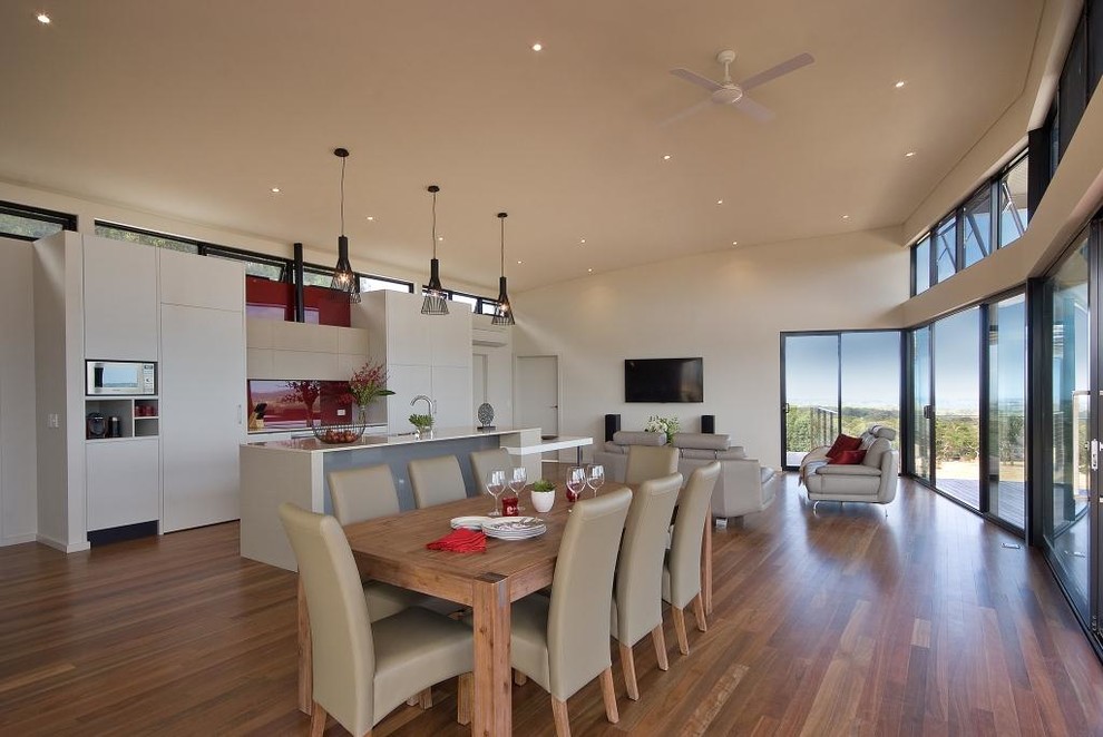 Photo of a medium sized modern open plan dining room in Adelaide with medium hardwood flooring and no fireplace.