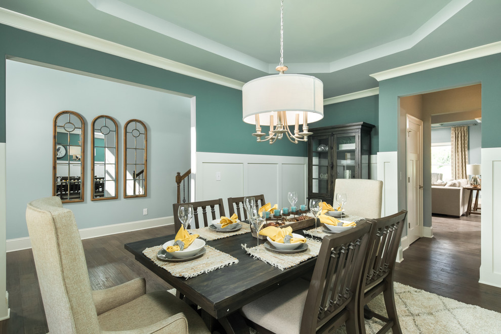 Medium sized traditional enclosed dining room in Other with green walls, dark hardwood flooring and brown floors.