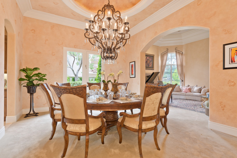 Example of a mid-sized tuscan carpeted enclosed dining room design in San Diego with beige walls