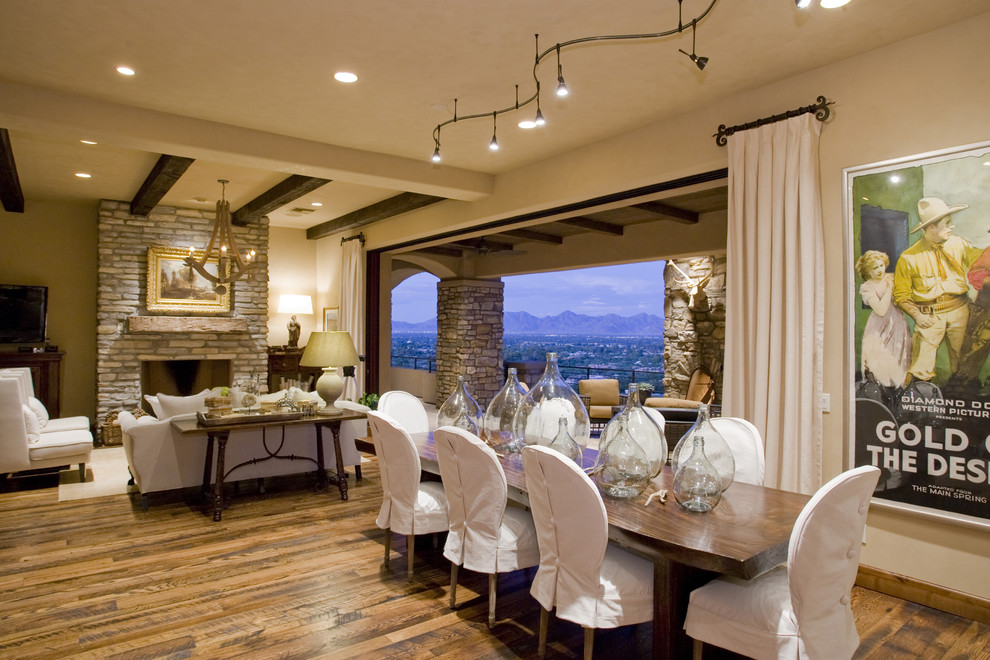 Photo of a rustic dining room in Phoenix with beige walls, dark hardwood flooring and feature lighting.