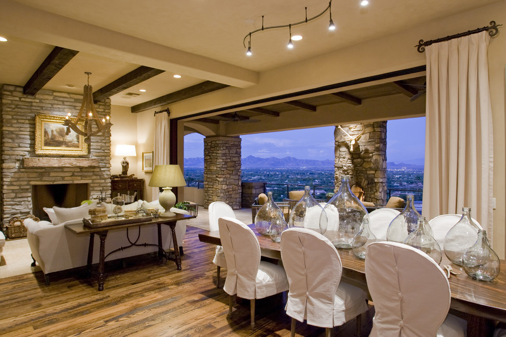 Rustic open plan dining room in Phoenix with beige walls and medium hardwood flooring.