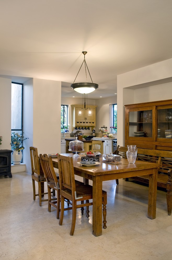 Photo of a mediterranean kitchen/dining room in Other with white walls.